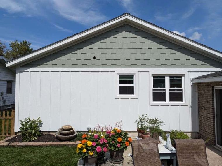 Completed home siding project with patio